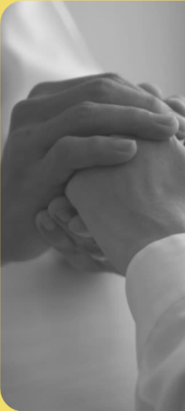 Doctor offering reassuring hand support to a patient